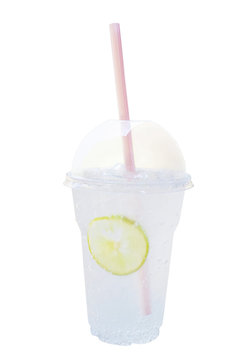Fresh cold lemon soda, carbonated lemonade soft drink in plastic cup with dome cap and straw isolated on white background, clipping path included.