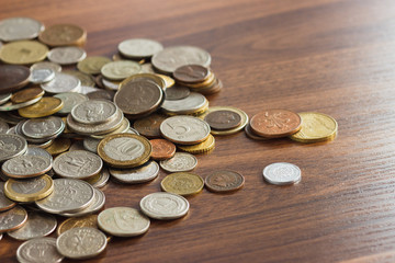 Different gold nad silver collector's coins on the wooden table