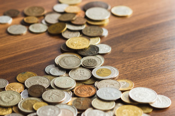 Different gold nad silver collector's coins on the wooden table