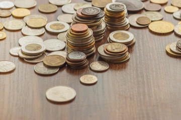 Different gold nad silver collector's coins on the wooden table