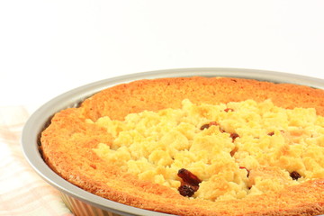 Baked apple pie on a white plate with a fork