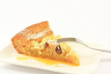 Baked apple pie on a white plate with a fork