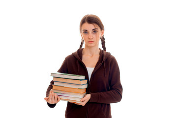 young girl with pigtails keeps the book in their hands and looking directly