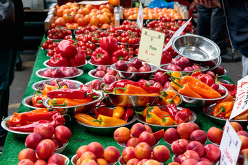 Variety of coloured bell peppers and other vegetable on display at Borough Market