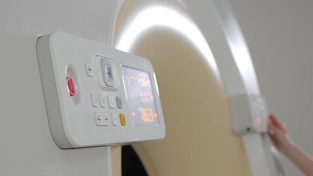 Tomography. Doctor hand adjusts MRI
