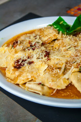 raviolis with onion and white sauce and cheese