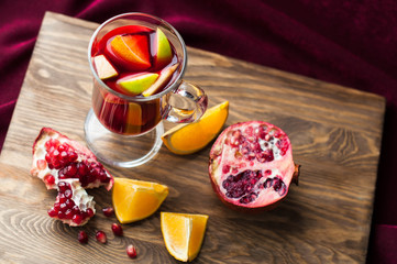 Fruits, pomegranates and oranges on the wooden table. Vitamin drink. Wine Sangria.