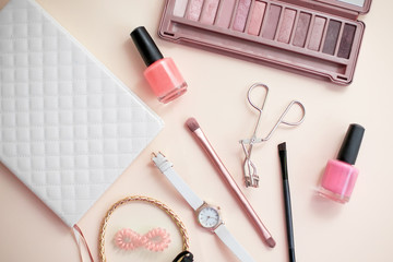 Fashionable women's cosmetics and accessories. Nail polish, eye shadow, brush, diary, watch. Top view.
