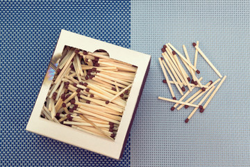 box of matches on the table and matches in bulk