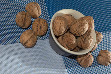 walnuts lie on the plate and in bulk