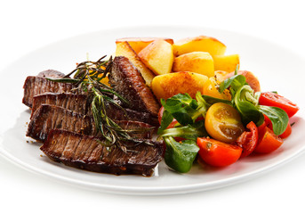 Steaks, baked potatoes and vegetable salad 