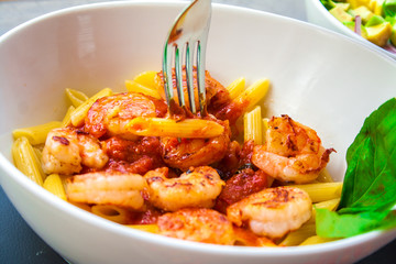 Italian food pasta pennes with shrimp and tomato sauc