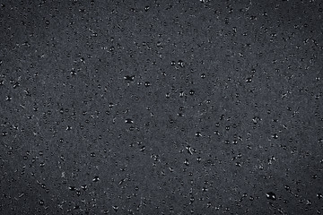 Fototapeta premium Water drops on dark stone