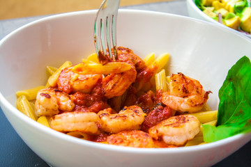 Italian food pasta pennes with shrimp and tomato sauc