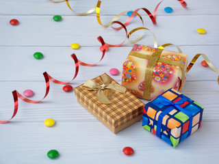three gifts on a light wooden background. Birthday