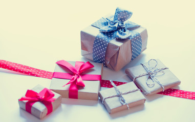 red dotted ribbon and beautiful gifts on the wonderful white background