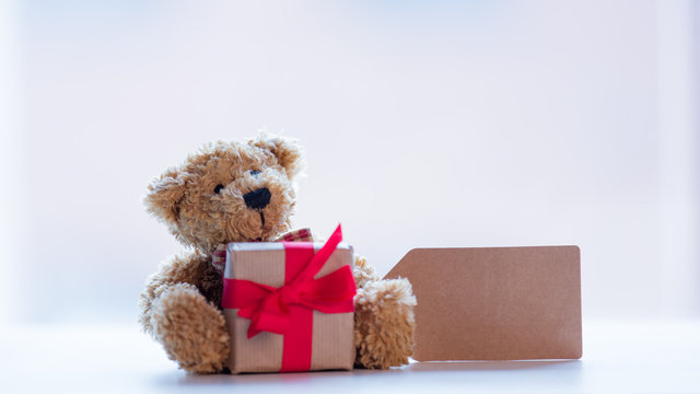 cute teddy bear with price tag and beautiful gift on the wonderful white background