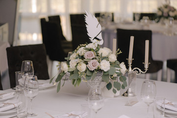 Wedding guest table decorated with bouquet and settings