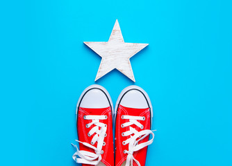 big red gumshoes and beautiful star shaped toy on the wonderful blue background