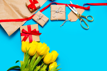 cute yellow tulips, beautiful gifts and cool things for wrapping on the wonderful blue background