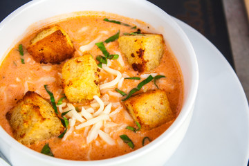 Cream of tomato with croutons and condiments