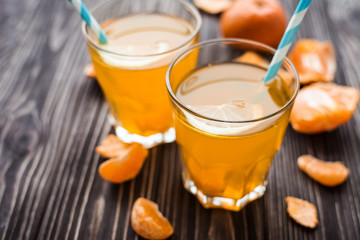 Freshly squeezed tangerine juice on a wooden background
