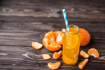 Freshly squeezed tangerine juice on a wooden background