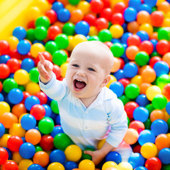 Child playing in ball pit on indoor playground