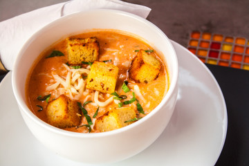 Cream of tomato with croutons and condiments