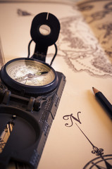 view of a compass over an old map. travel. vintage. direction