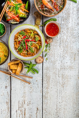 Asian food served on wooden table, top view, space for text © Jag_cz
