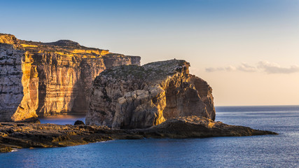 Gozo, Malta - The famous Fungus rock on the island of Gozo at Dwejra bay at sunset