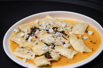 Pasta ravioli with bacon and spices
