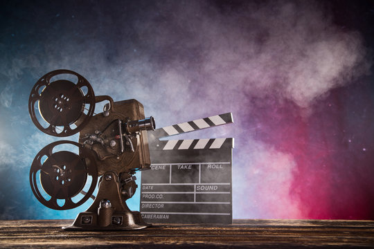 Old style movie projector with smoke on background, close-up.