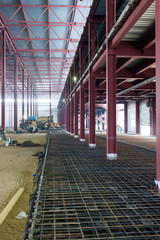 iron structures being built inside a large warehouse