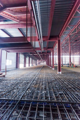 iron structures being built inside a large warehouse