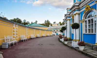 White benches placed in a row near Catherine Palace in Pushkin, Tsarskoye selo, Saint-Petersburg