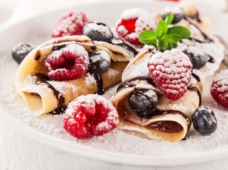 delicious pancakes on wooden table with fruits