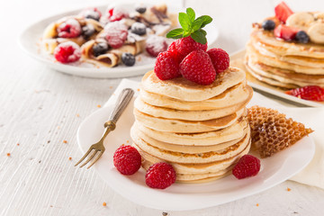 delicious pancakes on wooden table with fruits