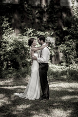 Bride and groom together in the garden, vintage style photo