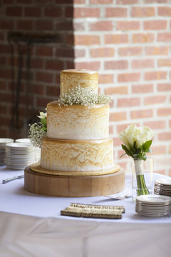 Three tiered wedding cake at outdoor reception
