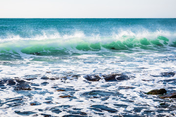 Fototapeta premium Perfect turquoise wave breaking at the beach