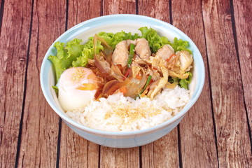Japanese rice topped boil eggs and fried pork.