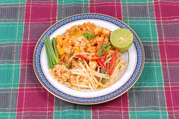 Popular Thai fried noodle call Pad Tai on Thai-pattern dish.