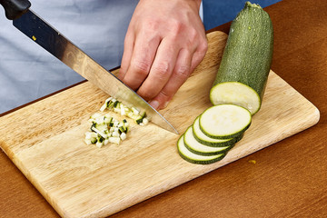 Fresh cucumber, chopped cucumber on wooden board Chef cuts the cucumber