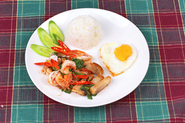 Jasmine rice topped stir - fried spicy basil with meat.