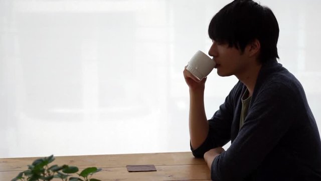 カフェでホットドリンクを飲む男性（コーヒー・紅茶・フィックス）