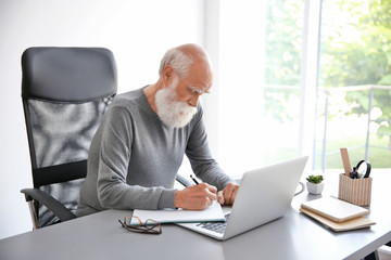 Man working with laptop in room