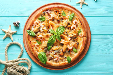 Delicious seafood pizza on turquoise wooden background