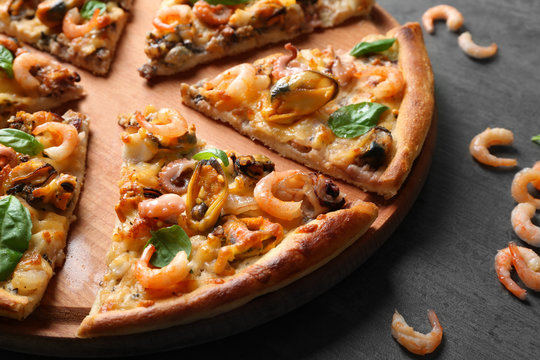 Tasty sliced pizza with seafood, closeup